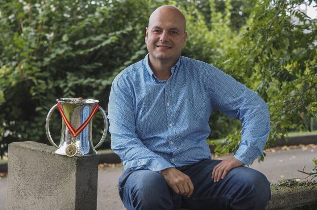 Jesús Salmón posa en la bolera de su casa, en Camargo, con el trofeo que le acredita como campeón de España de bolo palma de 2017/Antonio 'Sane'