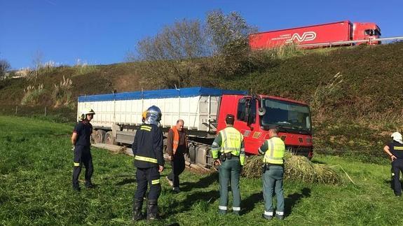 Los bomberos cortan la fuga de combustible de un camión caído por un terraplén